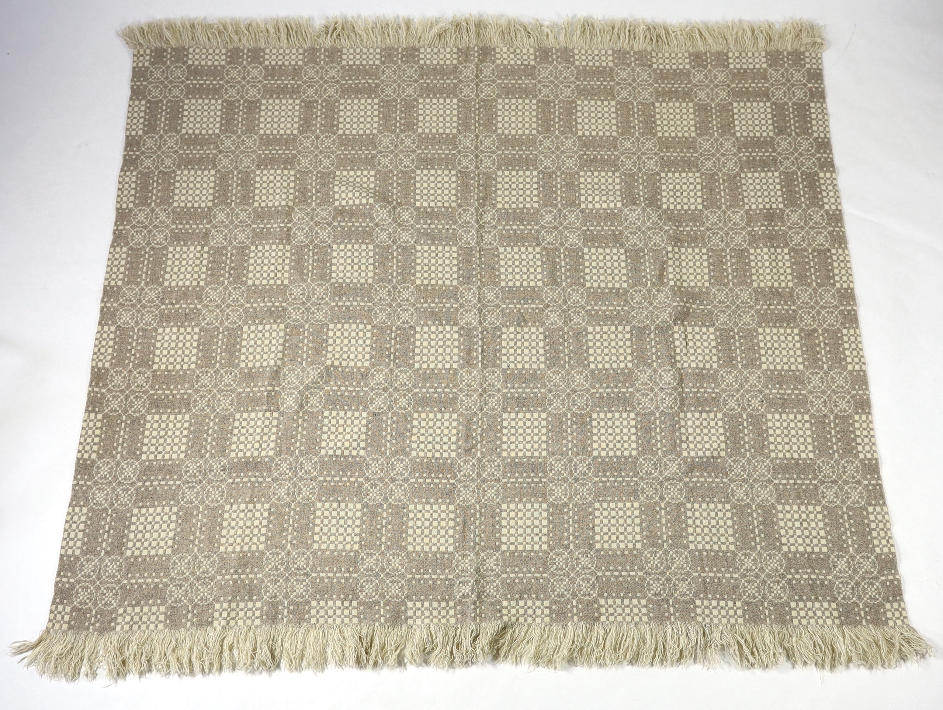 A Welsh wool woven blanket, using mushroom and cream wool in a reversible geometric design, 192cm wide x 212cm long